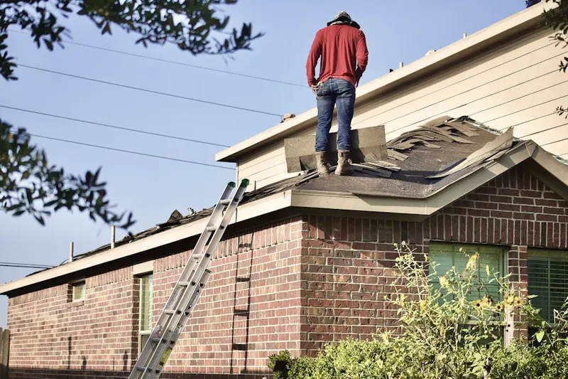 Professional roofer working on a residential roof in Saratoga